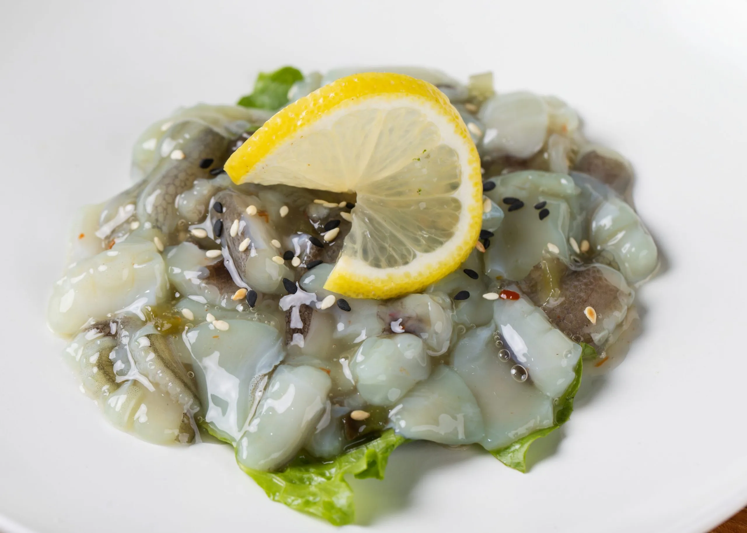 Fresh squid sashimi with sesame and lemon at Dozo Sushi & Bar, a Japanese Restaurant in Monrovia