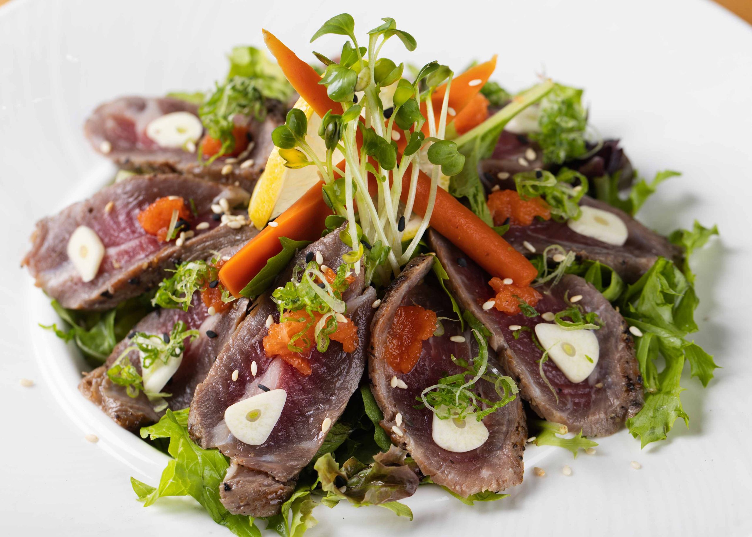 Spicy tuna sashimi with roe over greens at Dozo Sushi & Bar, a Japanese Restaurant in Monrovia